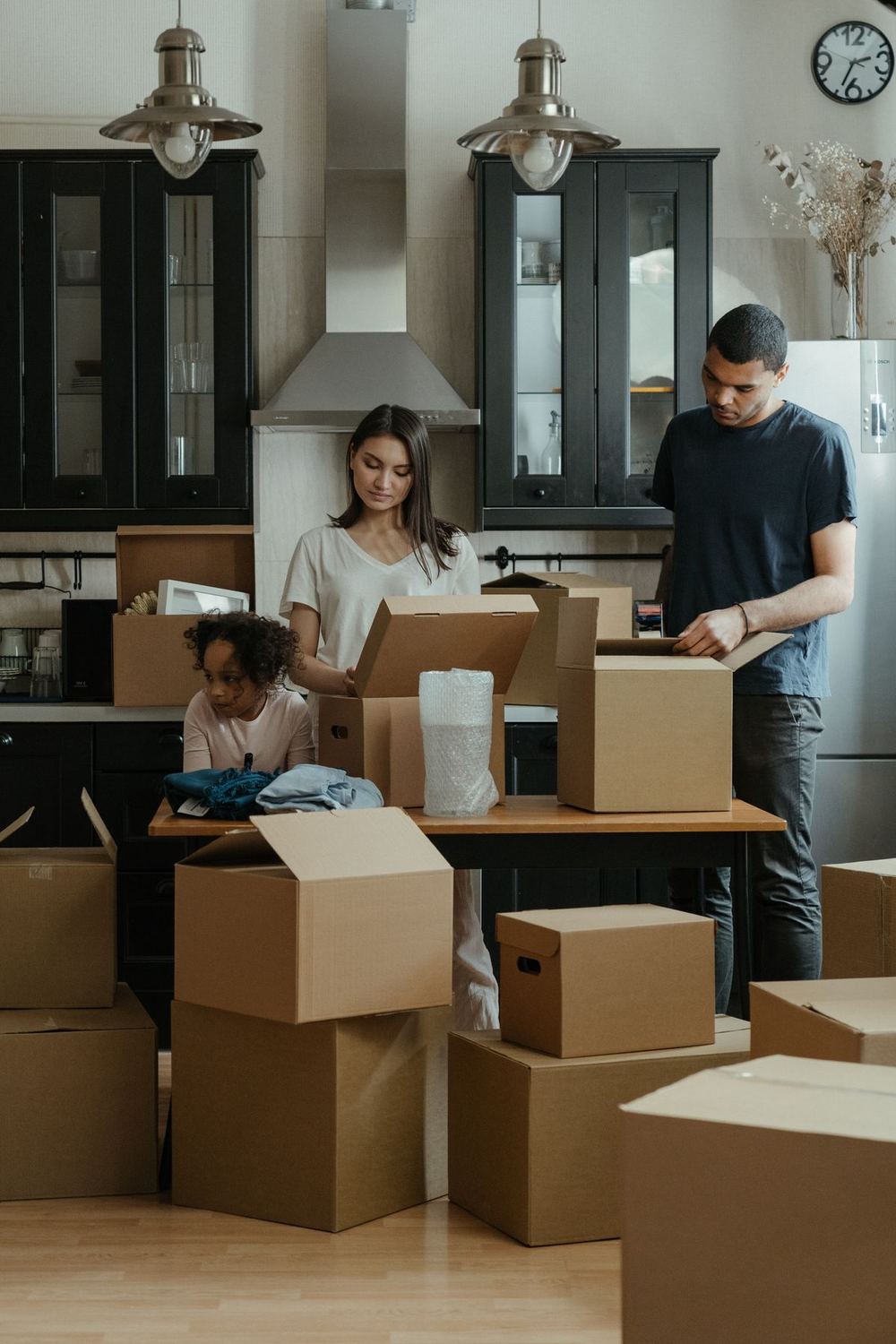 Family unpacking boxes together in their new home